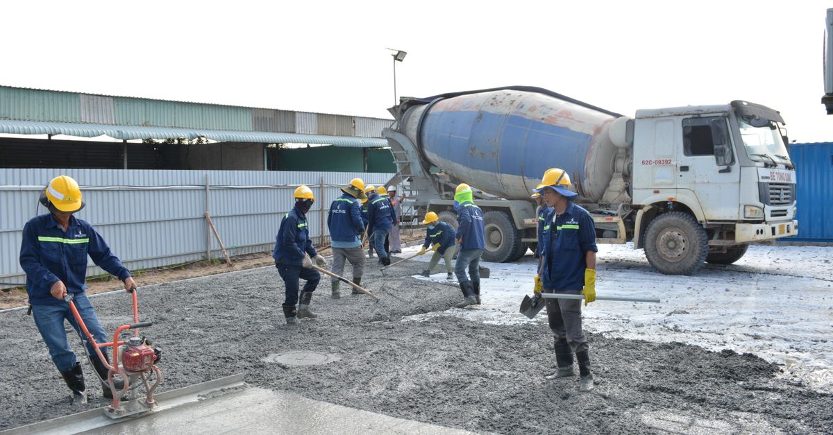 Concrete being poured on a construction site by an experienced crew